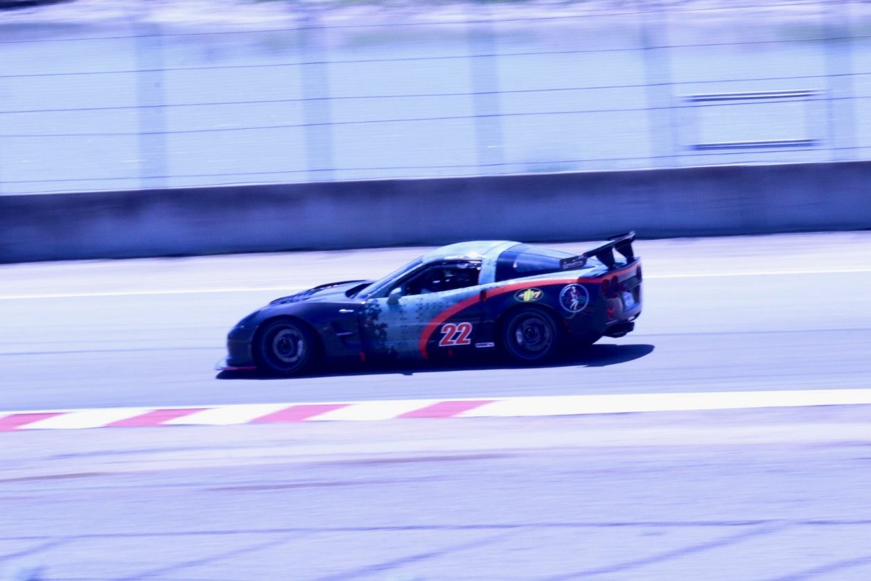 Black #22 C6 Corvette Z06 panning shot along the wall
