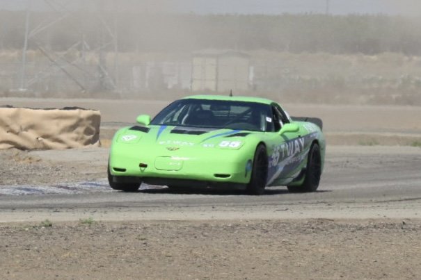 Green #55 C5 Corvette head-on at speed