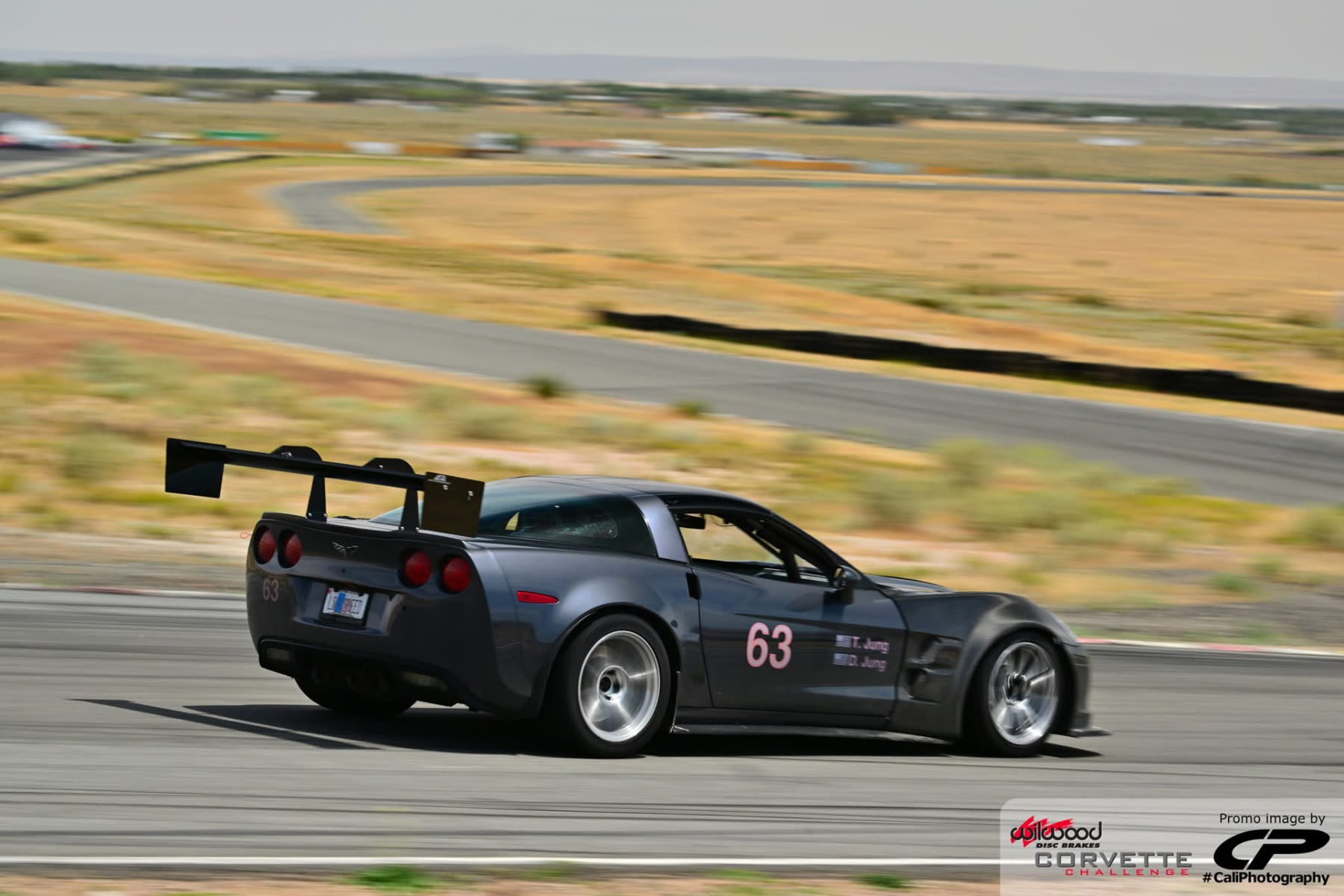 Gunmetal #63 C6 Corvette Z06 rear three-quarter on track