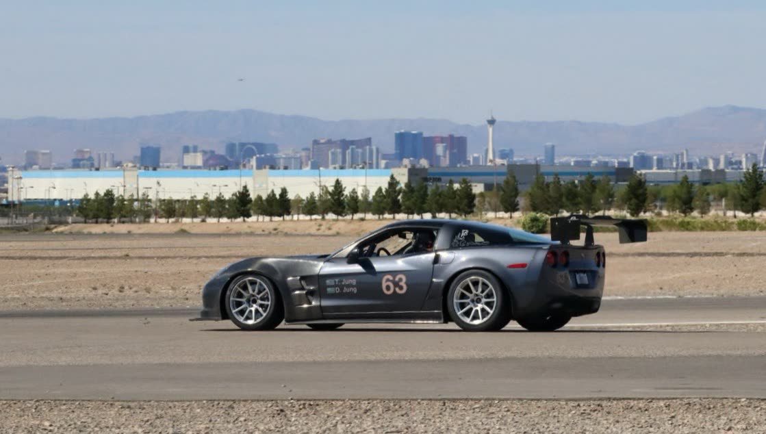 Gunmetal #63 C6 Corvette Z06 with the Las Vegas skyline behind